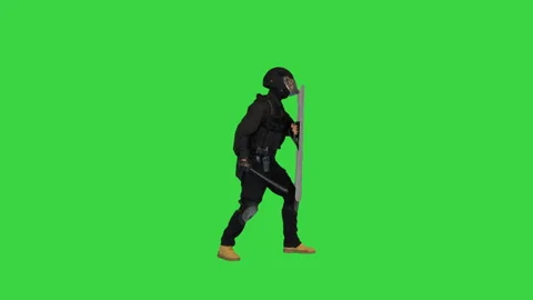 Special unit policeman running into the frame, holding shield up and hitting it 動画素材 144676018