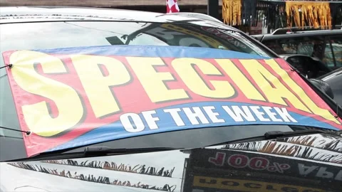 Special of the week words text sign banner flag on front of car vehicle Stock Footage 252044061