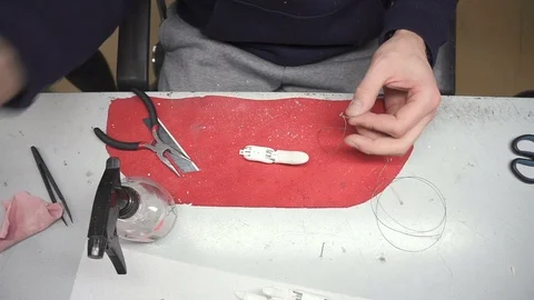 Specialist is assembling traction hand prosthesis sitting at table in workshop. Stock Footage 92320525