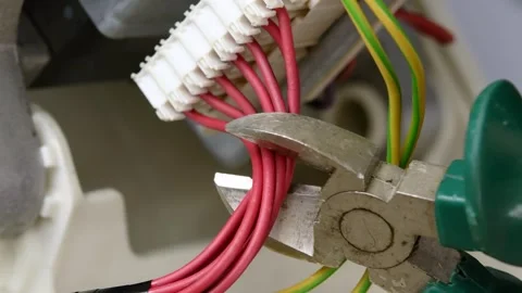 Specialist bites red wires with wire cutters. Stock Footage 287298014