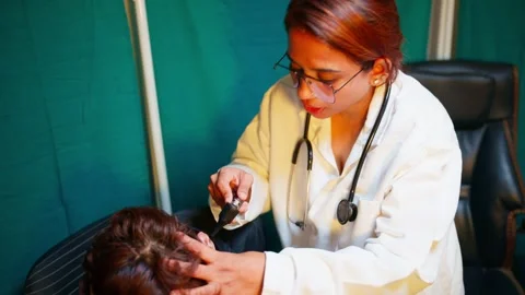 Specialist carefully examine eardrum with auriscope Stock Footage 299782860