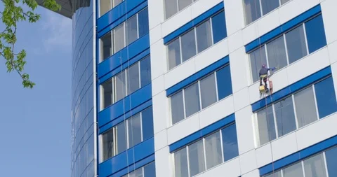 Specialist cleaning of windows running on a skyscraper Stock Footage 90579769