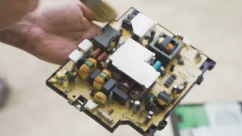 Specialist cleans the computer board from dust with a brush Video stock 108565062