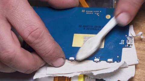 Specialist cleans the tablet with a small brush Stock Footage 107850467