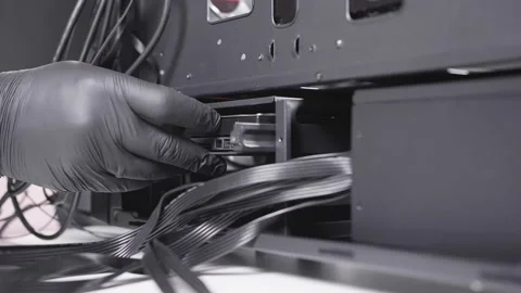 Specialist of a computer assembling workshop instal hard drive in its place Stock Footage 234048663