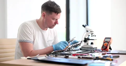 Specialist computer maintenance engineer analyzing laptop hardware through Stock Footage 237314830