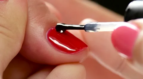 Specialist covers the nail of the client by fixer. Close up Stock Footage 68404738