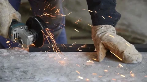 Specialist cut rectangular metal profile using angle grinder. People at work, Stockbeeldmateriaal 152233618