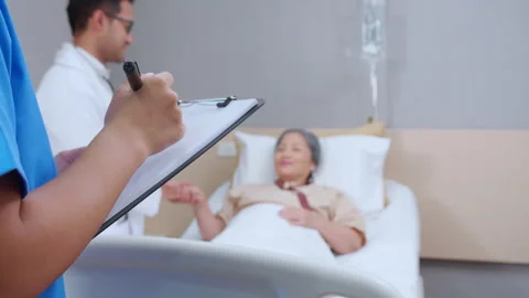 Specialist doctor man explaining and check with elderly patient while close.. Stock Footage 246634736