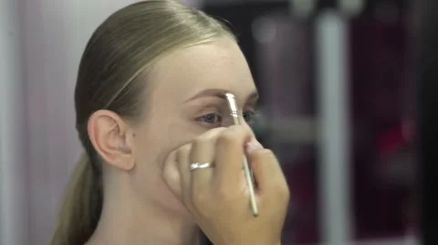 Specialist doing makeup for model. Gentle make-up for the young girl. Stock Footage 67318917