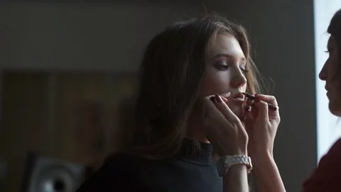 Specialist doing makeup for model. Gentle make-up for the young girl. Stock Footage 74124773