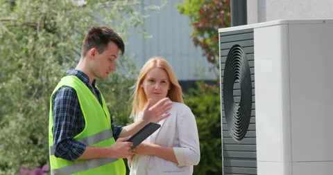 The specialist explains to the customer the principle of operation of the heat Stock Footage 242656411