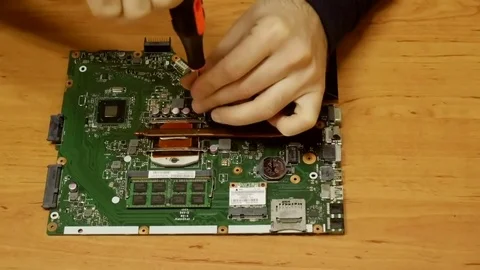 Specialist  Fixing laptop CPU and heat sink with screwdriver . Repair Stock Footage