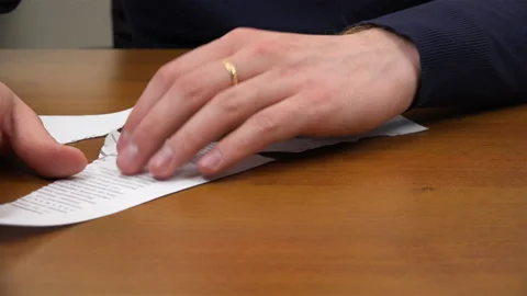 Specialist hands restore a printed document from different scraps Stock Footage 99941529