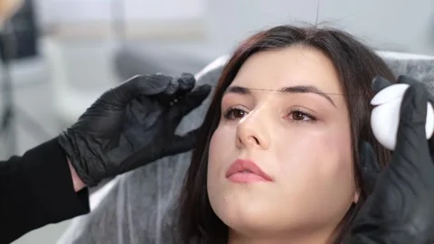 Specialist marks the clients eyebrows before procedure with special thread. Stock Footage 254813325