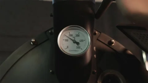 Specialist opening the roaster bin lever with temperature sensor view Stock Footage 334732462