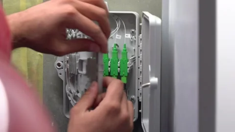 The specialist opens the fiber optic coupling Stock Footage 276425693