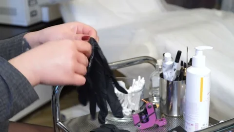 Specialist of permanent make-up wears rubber gloves of black color. Stock Footage 83324356