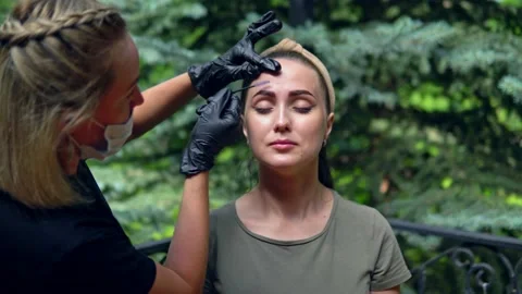 The specialist plucks his eyebrows on the model before staining. Stock Footage 202010316