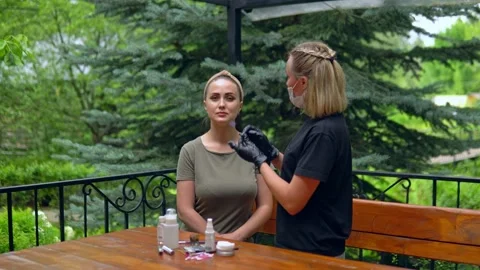 The specialist plucks his eyebrows on the model before staining. Stock Footage 202010693