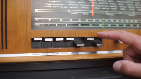 The specialist presses the buttons of the audio player of the old radio Stock Footage 115065018