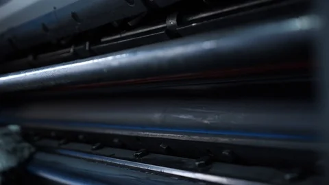 Specialist printer cleans the shaft of the printing press from the old paint. Stock Footage 98120664