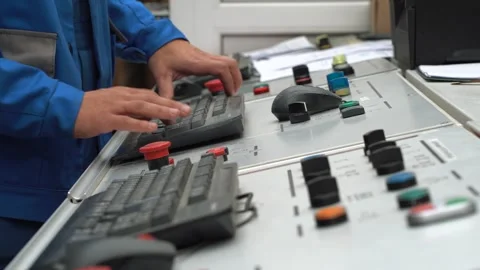 Specialist, programmer, engineer, factory employee works on control panel of CNC Stock Footage 280189200