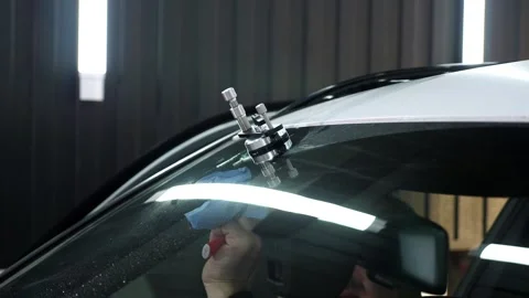 Specialist repairs crack in windshield on location without replacement glass. Stock Footage 312436694