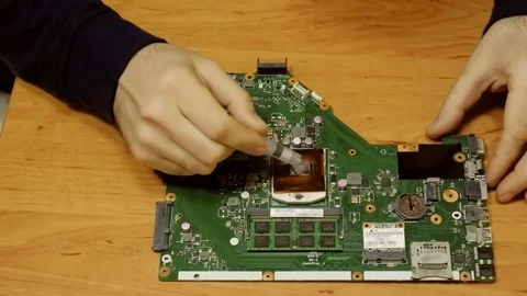 Specialist replace  thermal paste , clean the CPU and heat sink of laptop Stock Footage 81827137