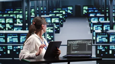 Specialist running code in server farm Stock Footage 248649602