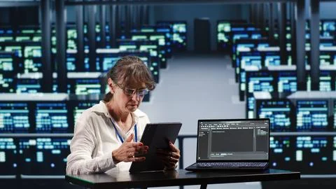 Specialist running code in server farm Stock Photos