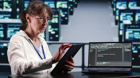 Specialist running code in server room Stock Footage 249969682