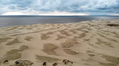 Specialist systematically documents fluctuating forms of beach dunes under Stock Footage 322116206