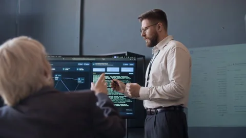 Specialist Talking to Colleague during Presentation in Cybersecurity Office Stock Footage 334930115