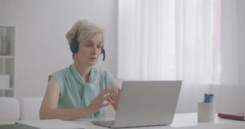 Specialist of tech support or call-center is consulting client online, woman Stock Footage 139439270