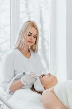 The specialist uses modern lifting methods to rejuvenate and improve the Stock Photos