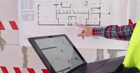 Specialist uses program on computer to study floor plan Stock Footage 309926999