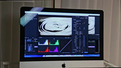 Specialist uses program settings to mount video on computer Stock Footage 231215399