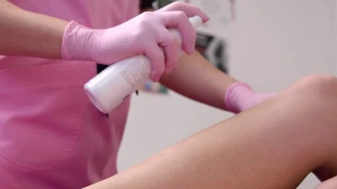 Specialist uses spray. Client is in salon. She is having hair removal procedure. Stock Footage 147123495