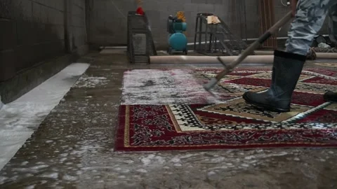 Specialist uses a squeegee to remove foam and solution, marking final cleaning. Stock-Footage 301503355