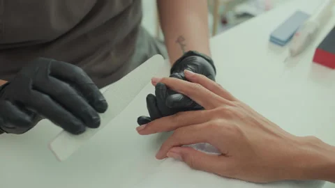 Specialist Using File to Shape Nails of Client at Studio Stock Footage 283466450