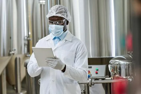 Specialist using tablet pc at factory Stock Photos