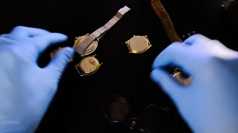 Specialist watchmaker selects old mechanical watches in his workshop. Man worker Stock Footage 129999237