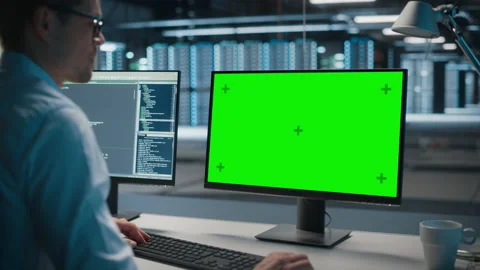 Specialist Working on Green Screen Computer in Data Center Stock Footage 167226433