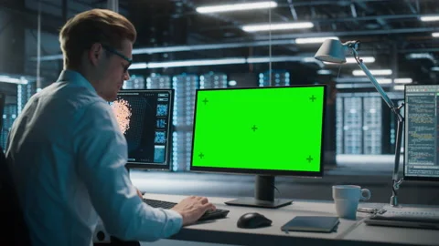 Specialist Working on Green Screen Computer in Data Center Stock Footage 167226570