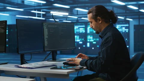 Specialist working in high tech facility doing system analysis, coding Stock Footage 276242020