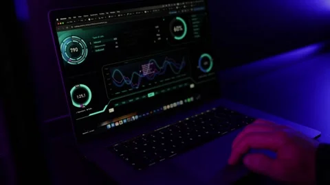 Specialist Working on Laptop with Code and Analytics in Dark Neon Office Stock Footage 336581235