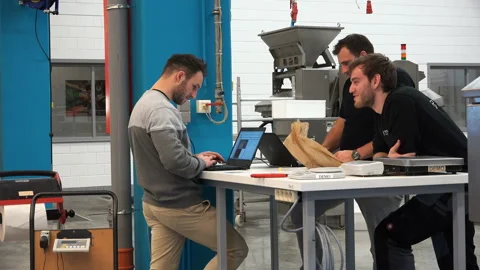 Specialists in amber sorting discuss work Stock Footage 92921201