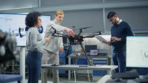 Specialists Looking At Drone And Discussing Stock Footage 189857645