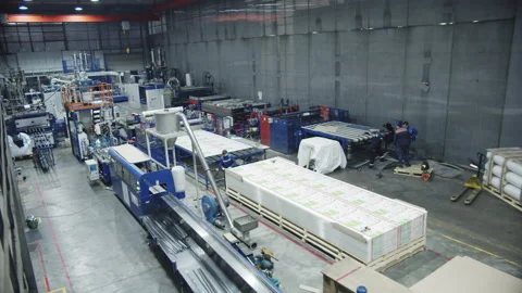 Specialists walk near polycarbonate sheets in workshop Stock Footage 231225754